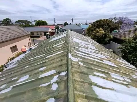 Old mossy corrugated roof being prepared